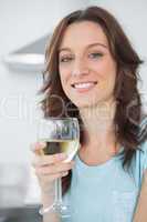 Brunette having a glass of white wine