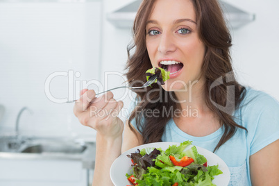 Brunette eating healthy salad
