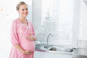 Expecting woman touching her belly