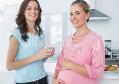 Happy pregnant woman and her friend