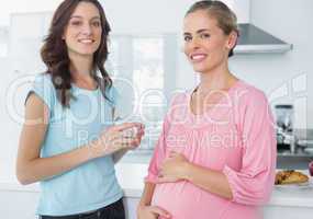 Happy pregnant woman and her friend