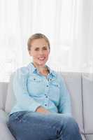 Blonde woman posing on sofa