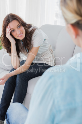 Happy woman sitting and looking at camera during therapy