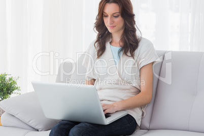 Relaxed woman with laptop on her knees