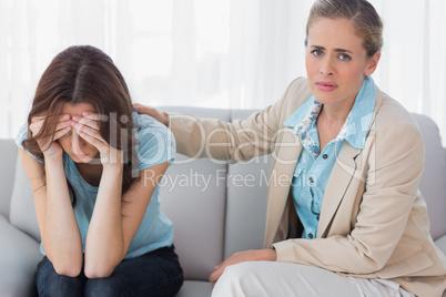 Worried woman being comforted by her understanding therapist