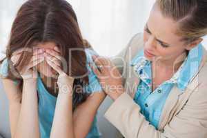 Upset woman being comforted by her understanding therapist