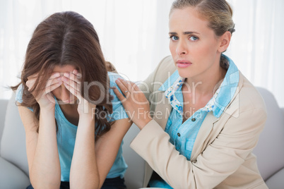 Crying woman with her worried therapist