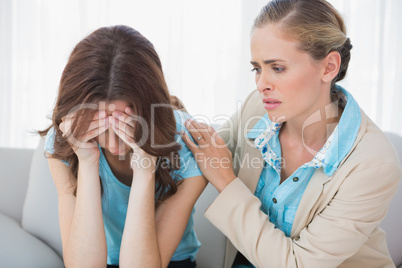 Crying woman with her concerned therapist