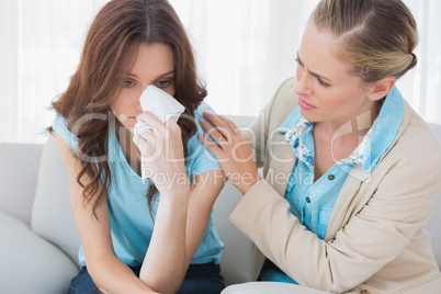 Blond therapist looking at her patient crying