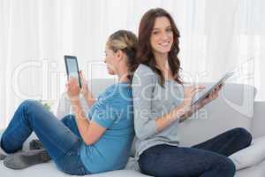 Happy women using tablet computer