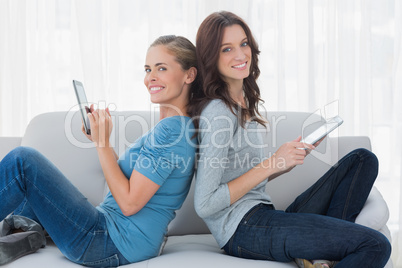 Cheerful women using tablet computer