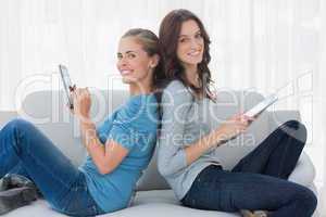 Cheerful women using tablet computer