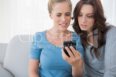 Friends watching something on their phone