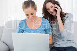 Women using laptop and having a phone call