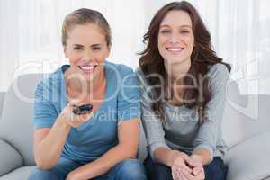 Laughing women watching television