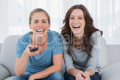 Laughing women watching television