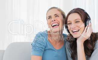 Cheerful women listening to music