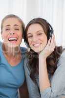 Laughing women listening to music