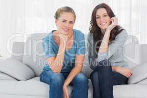 Pretty women posing while sitting on the couch