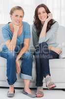 Relaxed women posing while sitting on the couch