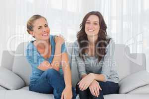 Natural women posing while sitting on the couch