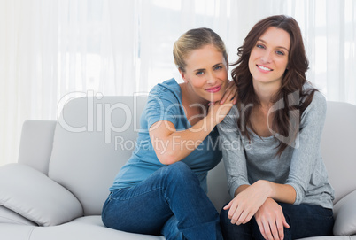 Friends posing while sitting on the couch