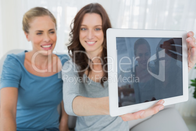 Friends taking pictures with tablet computer