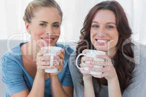 Friends having coffee and looking at camera