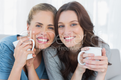 Smiling women holding their cup of coffee