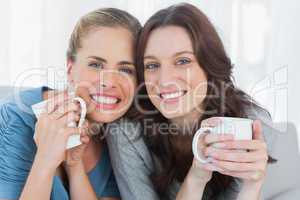 Smiling women holding their cup of coffee