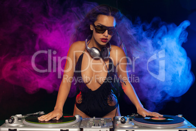 beautiful dj girl on decks on the party,