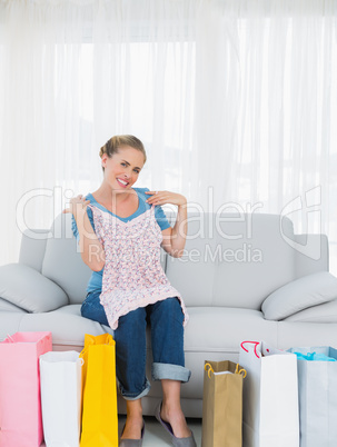 Woman with shopping bags trying out a new top