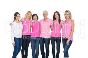 Smiling women wearing pink for breast cancer awareness