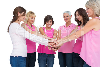 Cheerful women posing in circle wearing pink for breast cancer