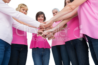 Enthusiastic women wearing pink for breast cancer posing in circ
