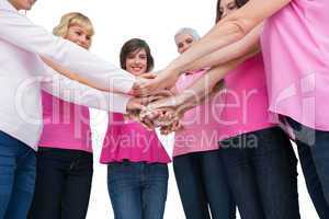 Enthusiastic women wearing pink for breast cancer posing in circ