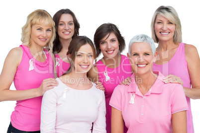 Smiling women posing and wearing pink for breast cancer