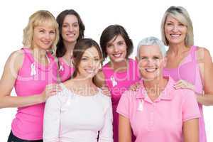 Smiling women posing and wearing pink for breast cancer