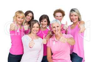 Positive women posing and wearing pink for breast cancer