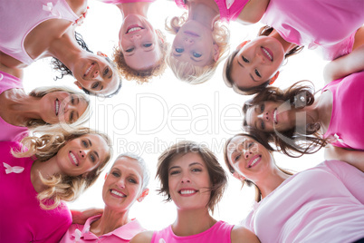 Group of happy women in circle wearing pink for breast cancer
