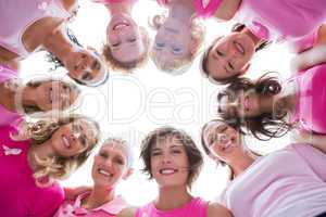 Group of happy women in circle wearing pink for breast cancer