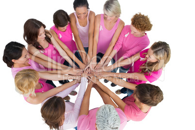 Cheerful women joined in a circle wearing pink for breast cancer