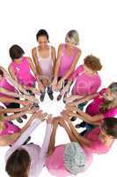 Happy women joined in a circle and looking at each otherwearing