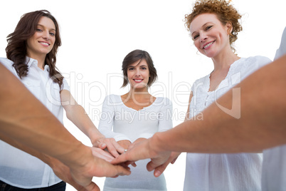 Cheerful models joining hands in a circle