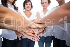 Relaxed women joining hands in a circle
