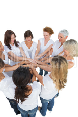 Happy female models joining hands in a circle