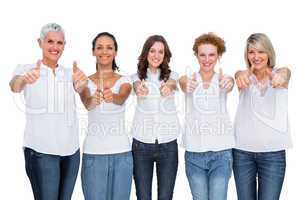 Cheerful casual models posing together with thumbs up