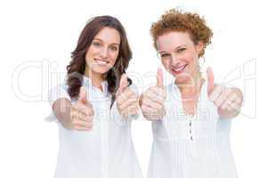 Two beautiful casual models posing with thumbs up