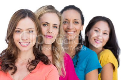 Smiling models in a line posing with colorful t shirts