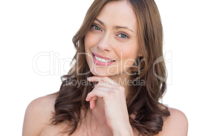 Pensive natural model posing with finger on chin